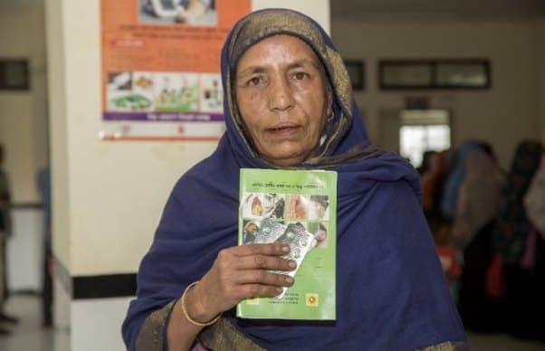 A patient with her hypertension treatment card at a health facility