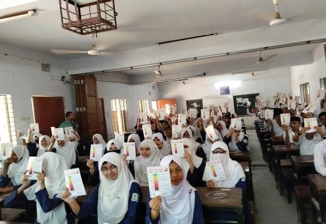Students holding up the Air Quality Index leaflets