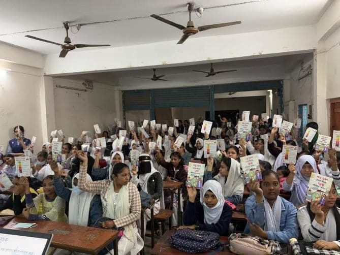 Students holding up the masks and leaflets they received